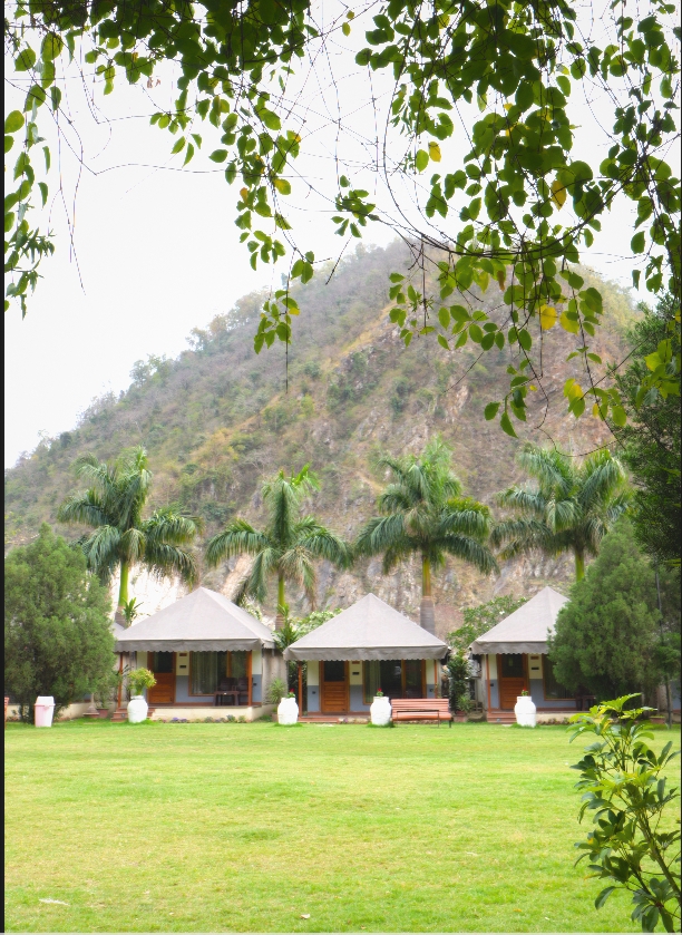 Spacious lawn and cottages at Maldevta Farms